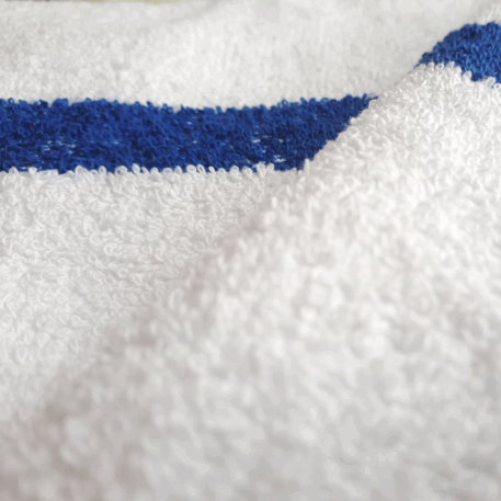 Close up image of a white towel with blue stripe. (Product Image)